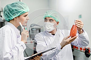 Quality control and food safety team inspection the product standard in the food and drink factory production line