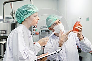 Quality control and food safety team inspection the product standard in the food and drink factory production line