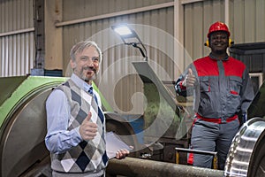 Quality Control Inspector And African American CNC Machine Operator Giving Thumbs Up In A Train Factory