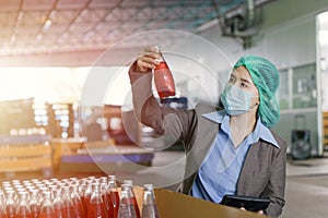 Quality Control Inspector Person Working in Drink factory to random check contaminate the final products photo