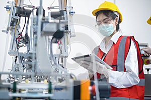 Quality control QC engineer monitoring and checking machine system in manufacturing factory