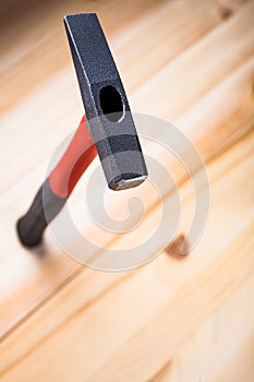 Quality hammer stands on a wooden table beautiful advertising hammer. focus on iron hammer. space for text. copy space