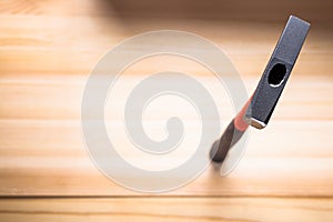 Quality hammer on a wooden table. focus on iron hammer, blurred background. space for text. copy space
