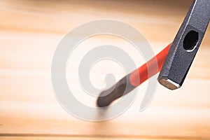 Quality hammer on wooden table. focus on the iron hammer, blurred background. space for text. copy space