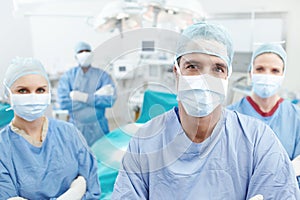 Quality medical care. Portrait of a medical team of surgeons standing together in an operating theatre before surgery.