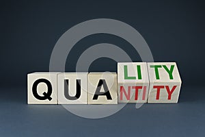 Quality or Quantity. The cubes form the choice words Quality or Quantity