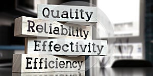 Quality, reliability, effectivity, efficiency - words on wooden blocks