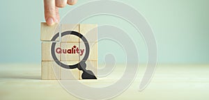 Quality warranty concept. Standardization, ISO. Hand placed wooden cube