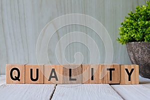 QUALITY words. Alphabets written on wooden block