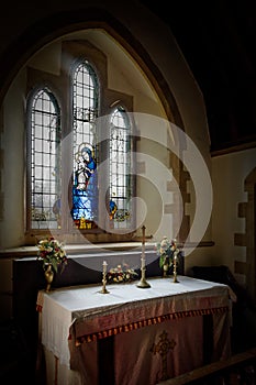 Quant old alter and stained glass window.