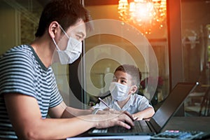 Quarantine asian man and children wearing protection mask working on computer at home selected focusing on children face