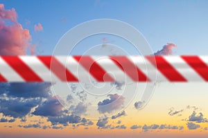 Quarantine concept. Blue sky with red warning tape, abstract background