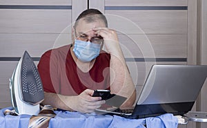 Quarantine due coronavirus pandemic. stay at home. business man working from home, wear a protective mask.