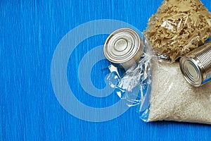 Quarantine food stock on blue background. Canned food, cereals. Delivery. Donation. Copyspace