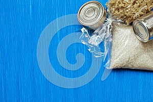 Quarantine food stock on blue background. Canned food, cereals. Delivery. Donation. Copyspace