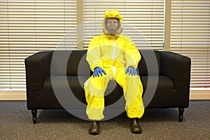 Quarantine - home arrest, man in protective uniform waiting.