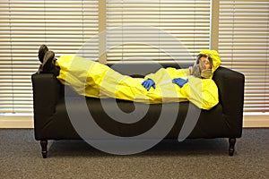 Quarantine - home arrest, man in protective uniform waiting.