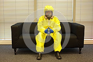 Quarantine - home arrest, man in protective uniform waiting.