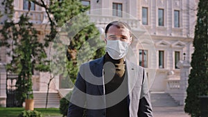 In the quarantine a man with a protective mask walking down the street in front of the camera he suggesting that it s