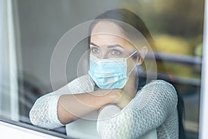 Quarantine measures of a woman with mild symptoms, wearing face mask even in isolation