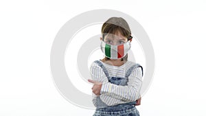 Quarantine, virus and pandemic concept. On the child a protective medical mask with flag of Italy