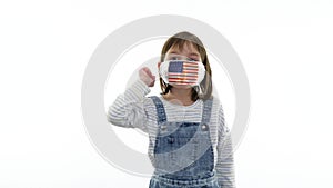 Quarantine, virus and pandemic concept. On the child a protective medical mask with flag of USA