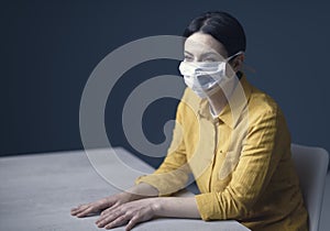 Quarantined woman with covid-19 wearing a face mask