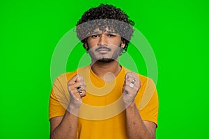 Quarrel, indian man showing fig negative gesture, rapacious, avaricious, acquisitive, refusal sign photo