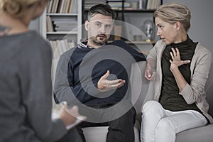Quarreling couple with therapist photo