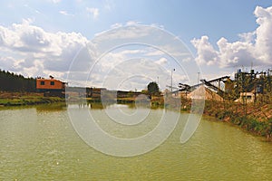 Quarry aggregate with conveyor belt and quarry crane. Construction industry. Horizontal photo