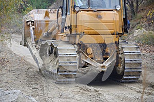 Quarry aggregate with heavy duty machinery. Caterpillar loader Excavator with backhoe driving to construction site quarry