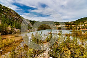 Quarry explored by scuba divers. Flooded quarry for adrenaline hobby. Diver site with fresh blue and clean crystal water with