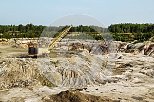 Quarry for the extraction of clay with excavator.