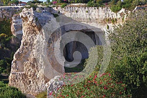 Quarry, limestone cave in archaeological park. Syracuse, Sicily, Italy