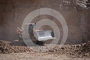 Quarry Mining movers excavators working on breaking the rocks
