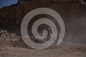 Quarry Mining movers excavators working on breaking the rocks
