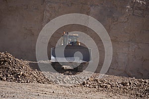 Quarry Mining movers excavators working on breaking the rocks