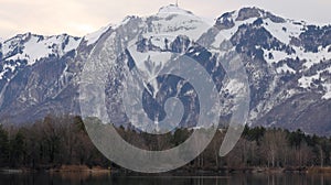 Quarry pond with forest and mountains in background