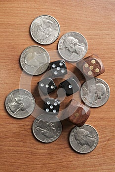 Quarter coins and dice on a wooden table