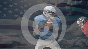 Quarterback catching the ball and being tackled with the american flag on the background