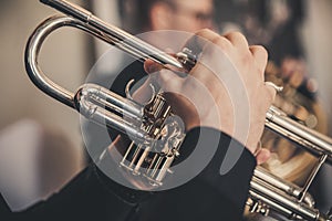 Quartet of brass instruments - Brass instruments - Close-up of hands - slight desaturation