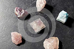 Quartz crystal pyramid and gem stones on slate