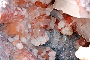 Quartz crystal with red orange calcite