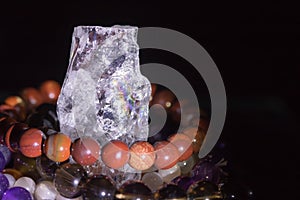 Quartz geode with semiprecious gemstone bracelets charging, spirituality concept, alternative medicine