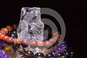 Quartz geode with semiprecious gemstone bracelets charging, spirituality concept, alternative medicine