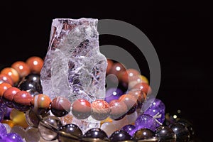 Quartz geode with semiprecious gemstone bracelets charging, spirituality concept, alternative medicine