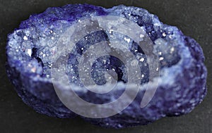 Quartz with mineral crystals against a black background