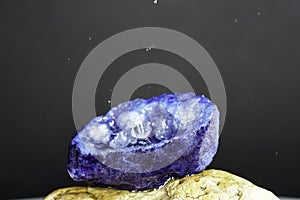 Quartz with mineral crystals against a black background