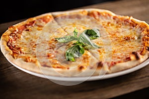 Quattro formaggi pizza with four types of cheeses, crusty edges and fresh basil on top