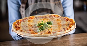 Quattro formaggi pizza with four types of cheeses, crusty edges and fresh basil on top